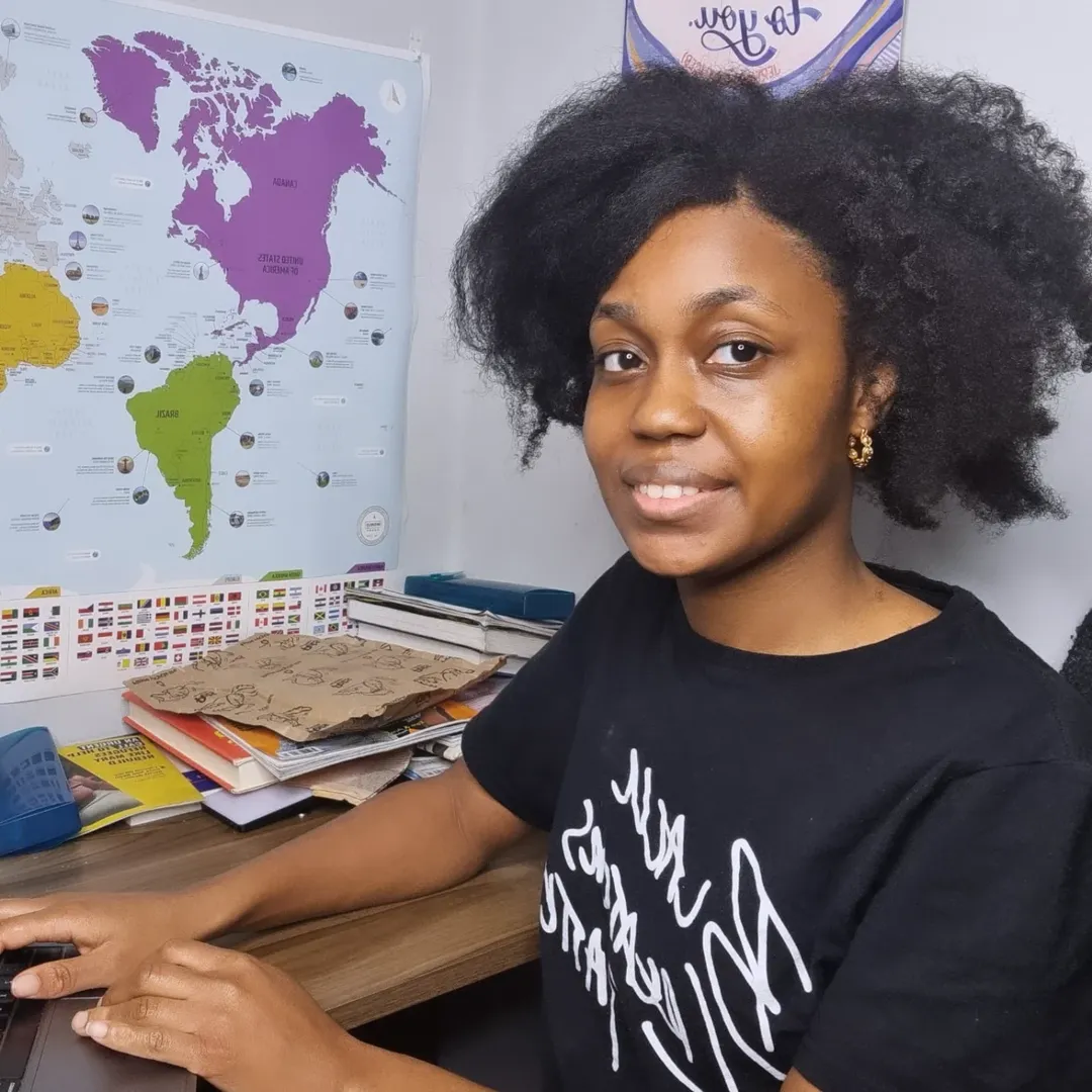 Client Maxine smiling at desk, shared a review about our mentoring services.